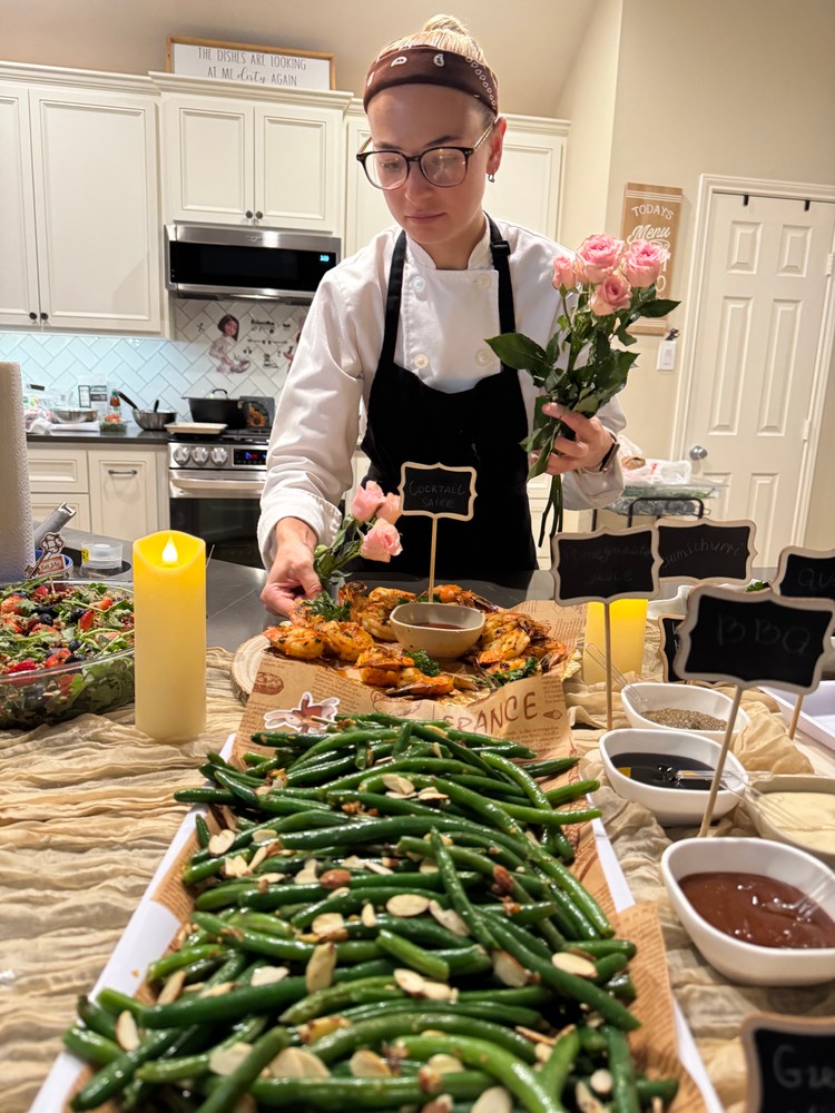 Chef Ana setting up the buffet with green beans and other dishes