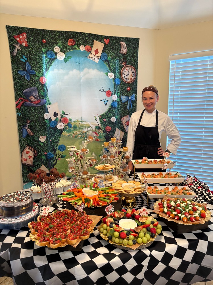 Chef Ana with a wide buffet selection in a decorated room