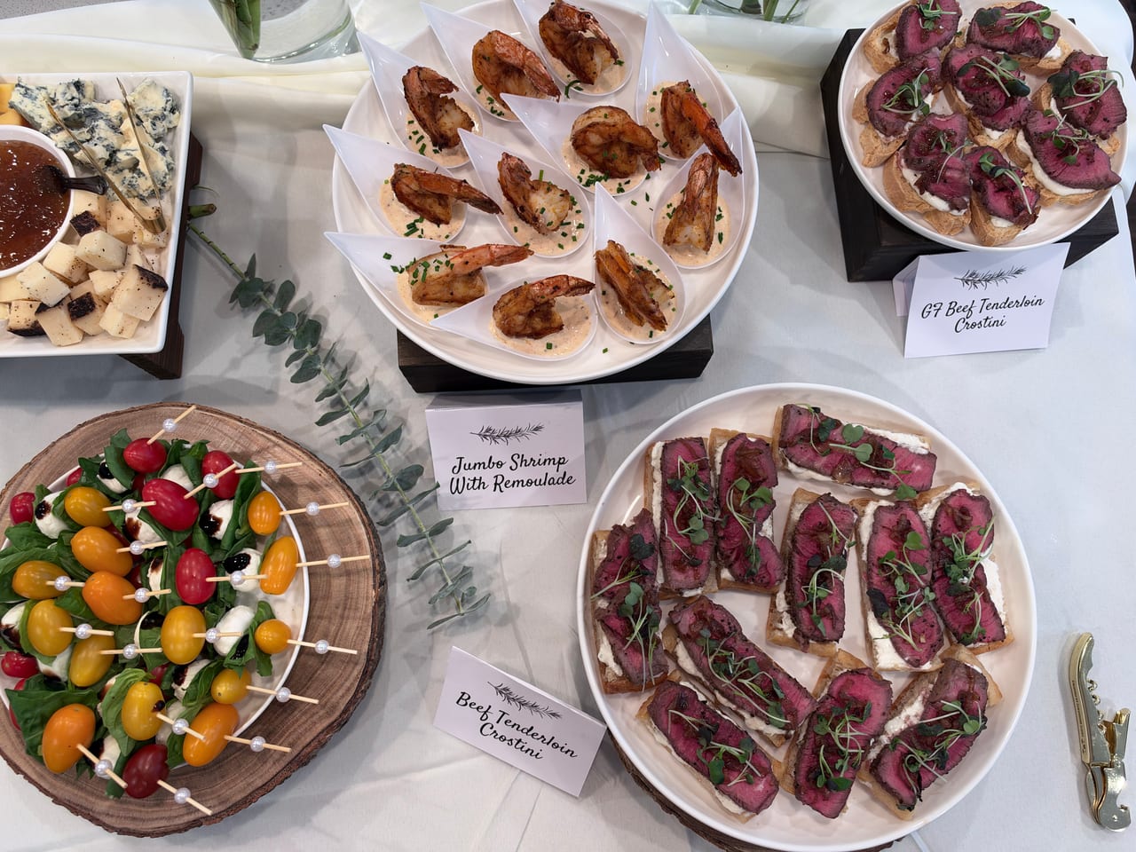 Overhead view of beef crostini, shrimp and Caprese skewers.