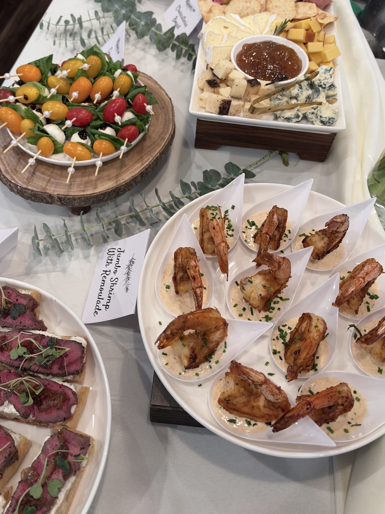 Shrimp, beef crostini and skewers viewed from above on the appetizer table.