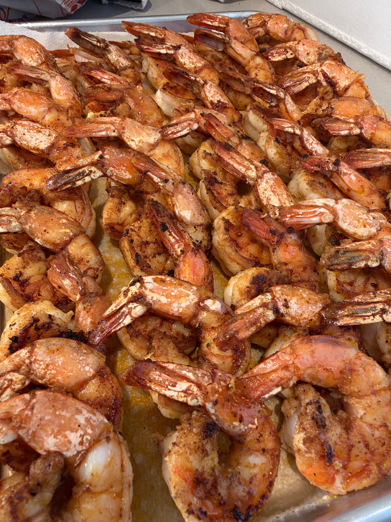 A close view of cooked shrimp arranged on a serving tray.
