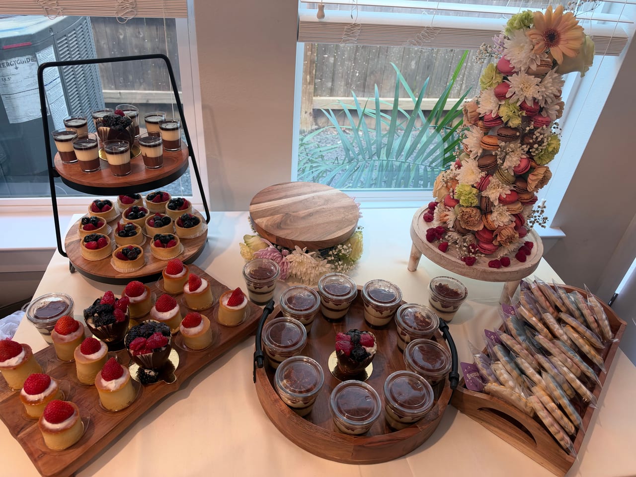 Small desserts on a tiered stand beside other serving pieces.