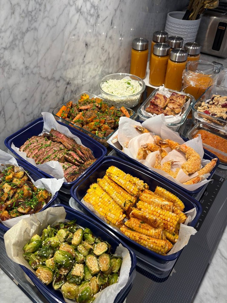 Top-down view of organized meal prep containers on a countertop.