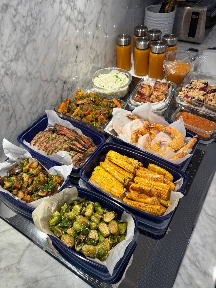 Close-up of diverse meal prep dishes, including proteins, vegetables, and desserts.