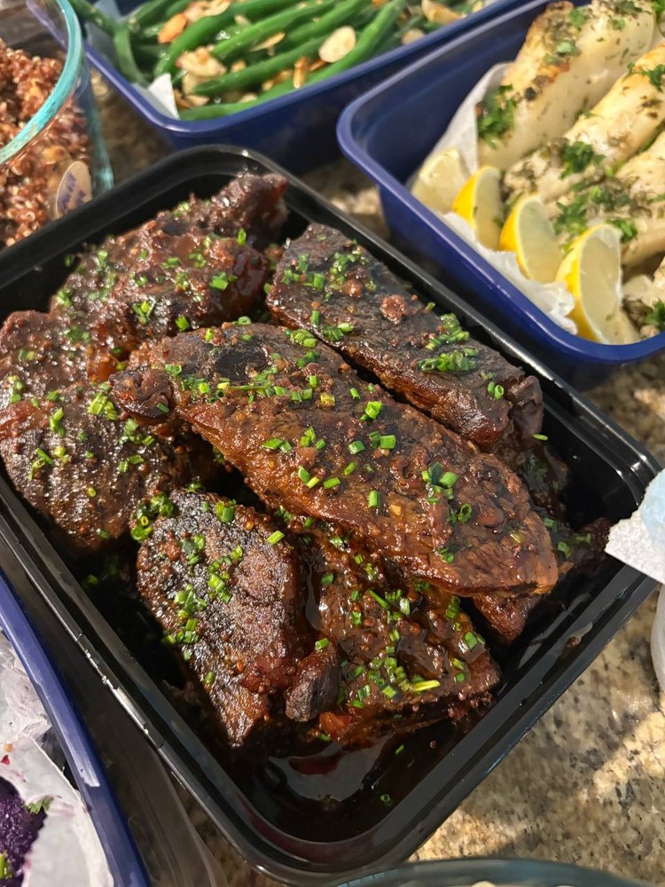 Close-up of braised beef ribs with chives.