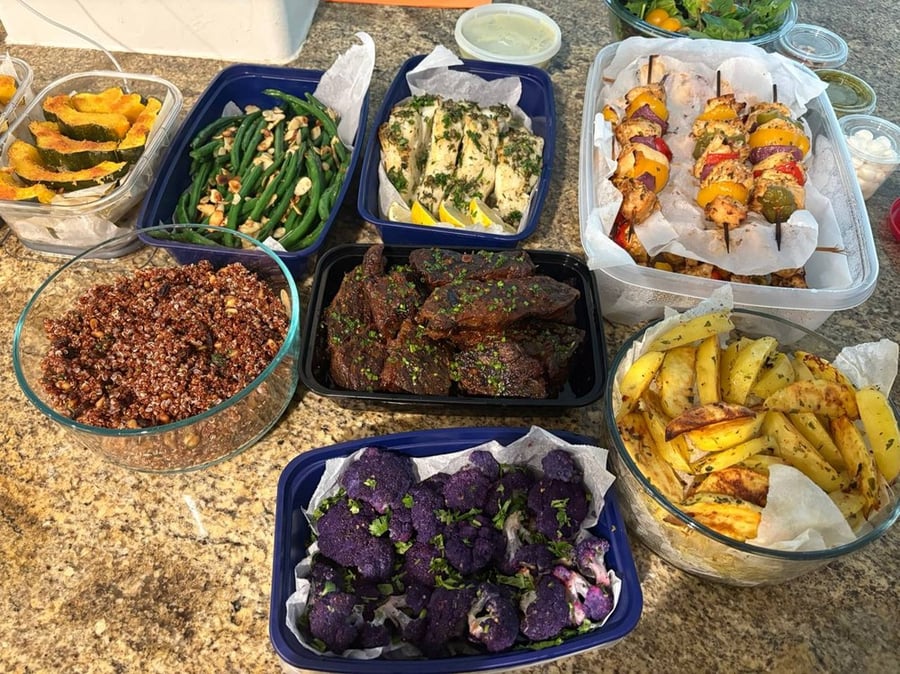 Overhead shot of various prepared meals in containers.