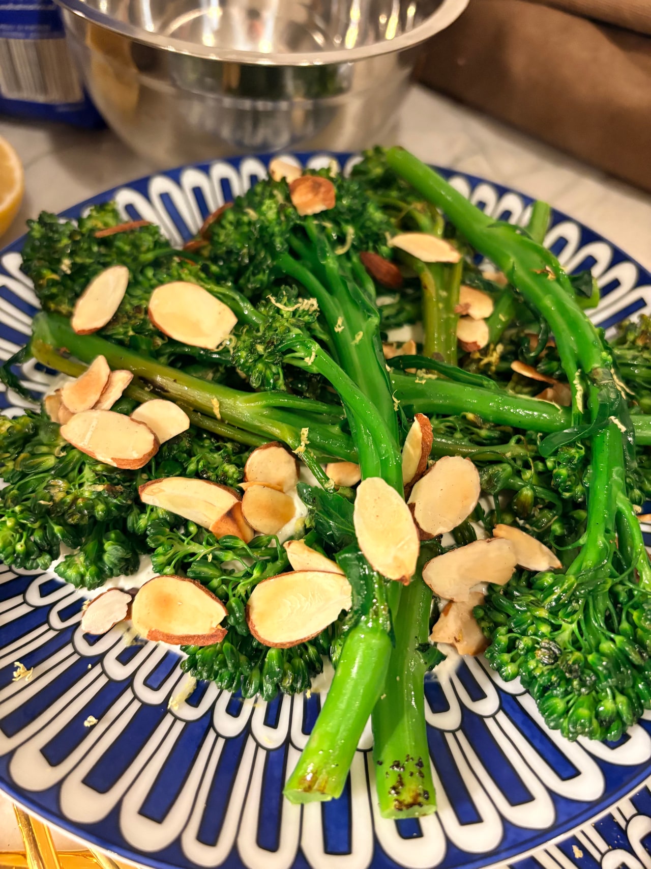 A close view of broccolini stems and florets with sliced almonds.