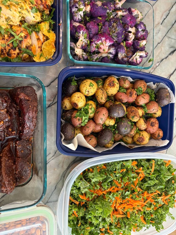 Colorful roasted potatoes, purple cauliflower, and kale salad.