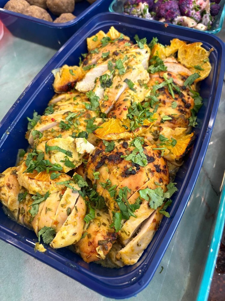 Close-up of grilled orange chicken with fresh cilantro.