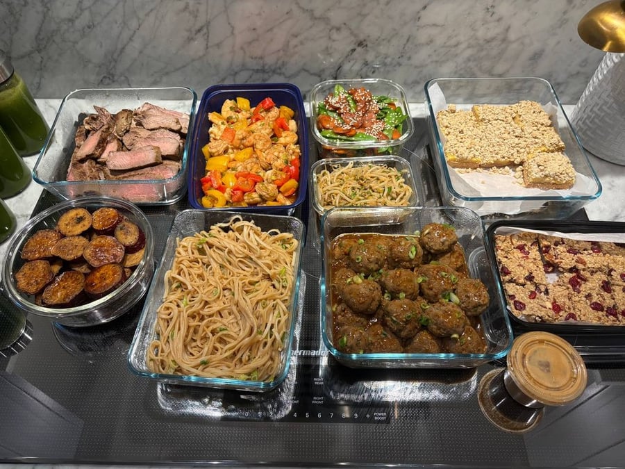 Overhead view of multiple meal prep containers on a counter.