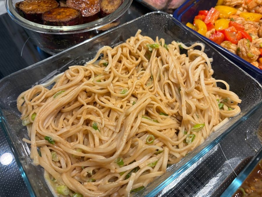 Close-up of peanut noodles with green onions.