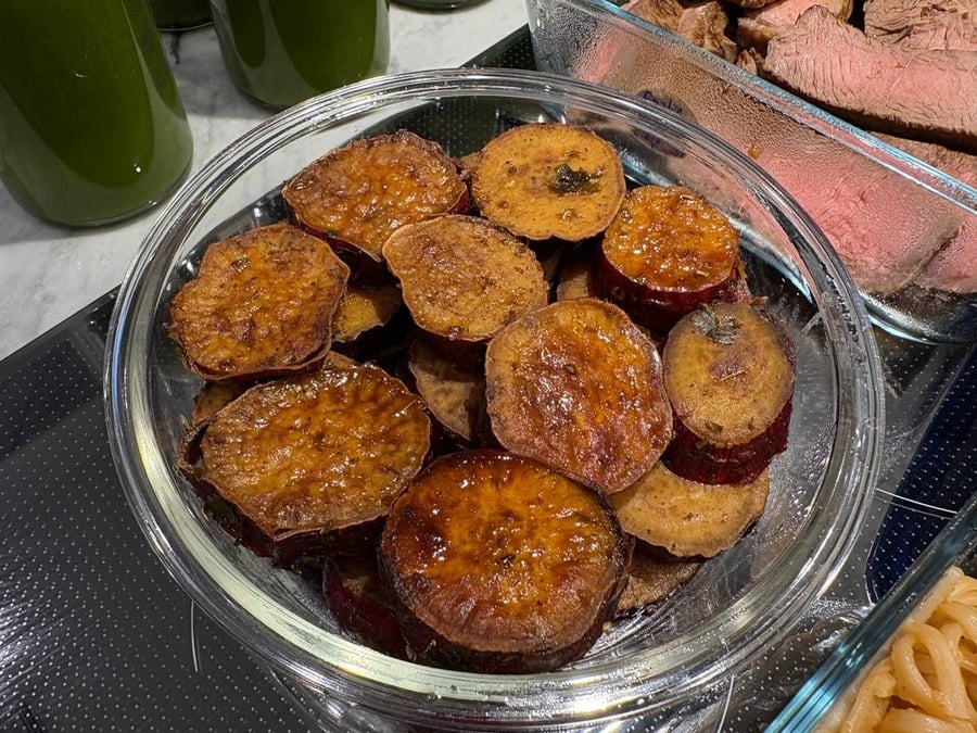 Roasted sweet potato rounds in a clear bowl.