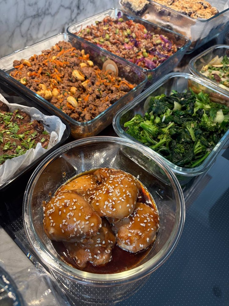 Angled view of sesame chicken, ground meat, and broccoli.